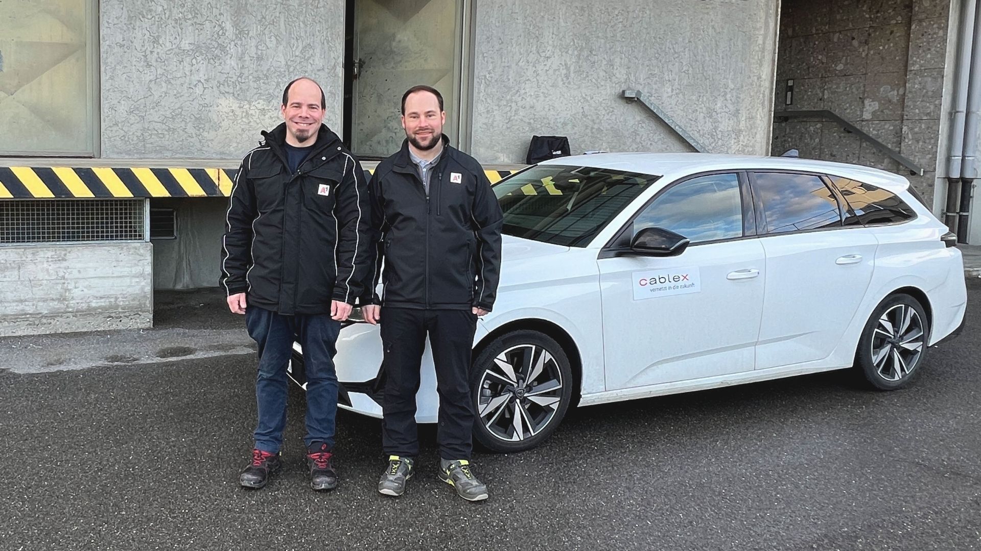 Zwei cablex Servicetechniker vor dem Auto in Österreich