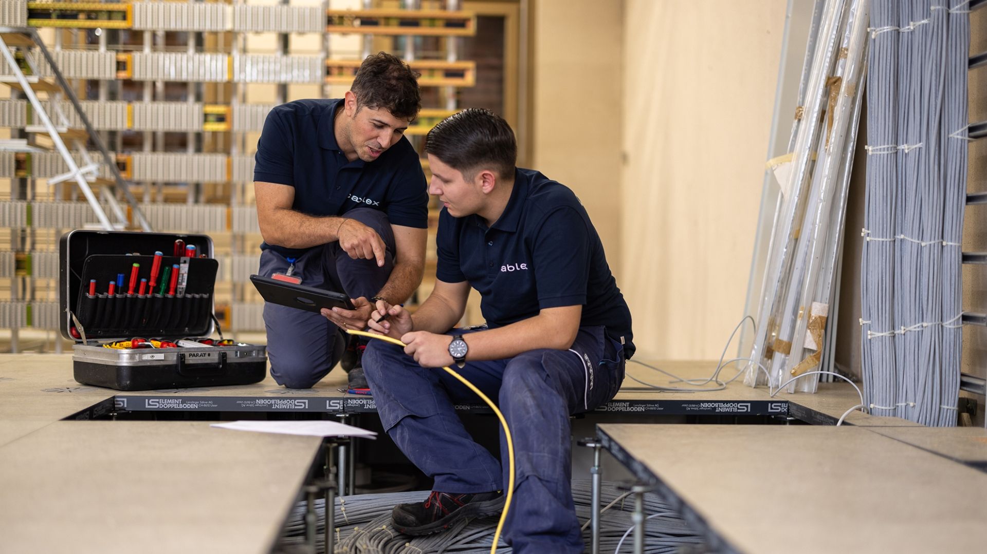 Installation Electrician at cablex lays cables on the floor
