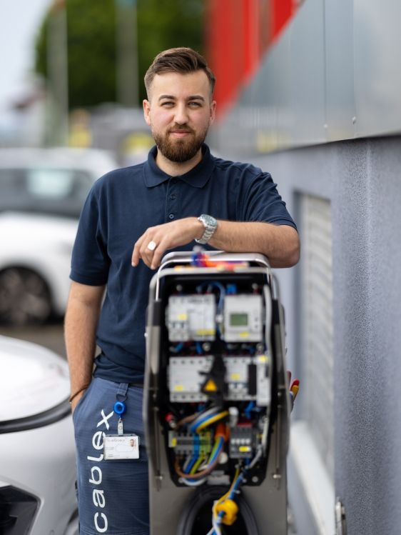 cablex technician in front of charging station
