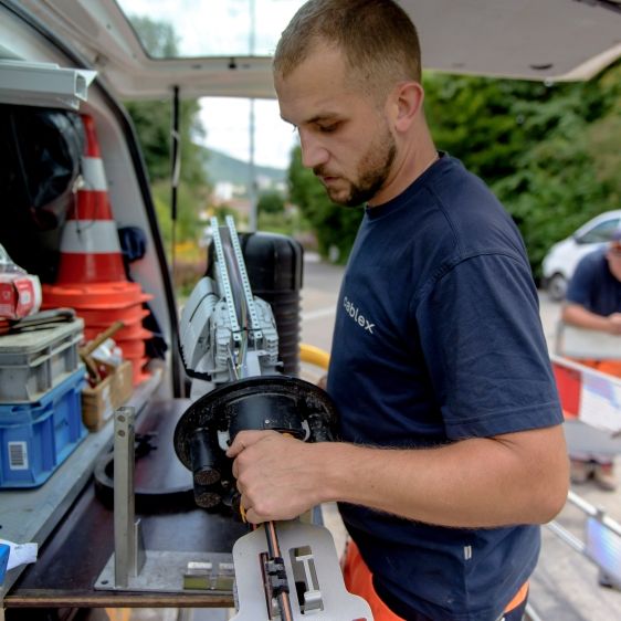 Apprentice network electricians at work outdoors